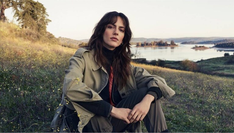 Woman sitting on the grass in the nature.