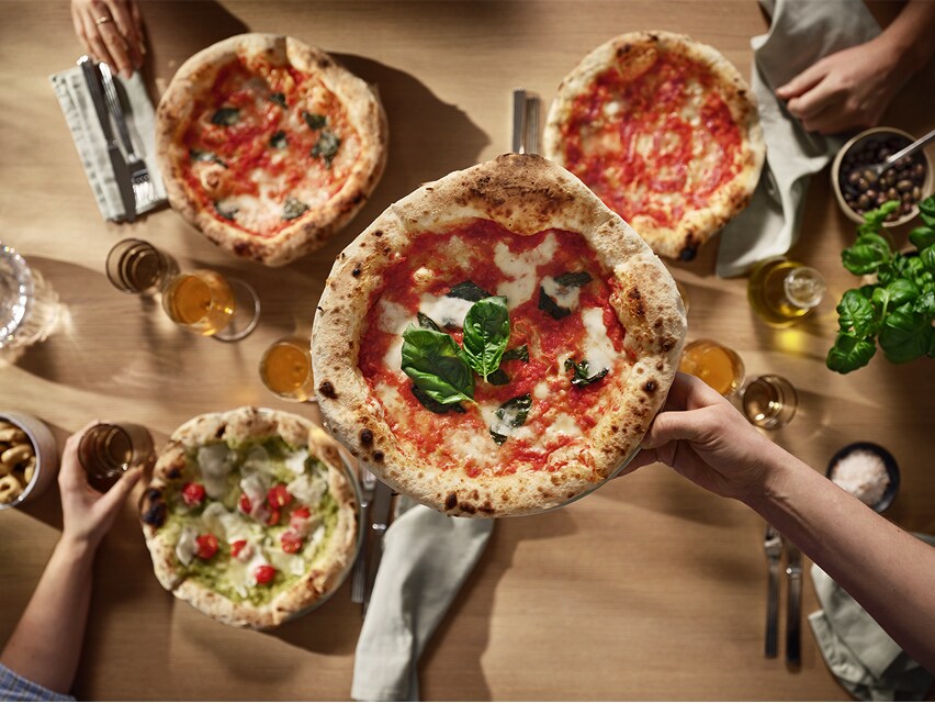 Top view of 4 pizzas.